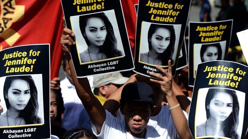 Supporters of the late Jennifer Laude hold up her image during a protest near a Philippine court in Olongapo, north of Manila on February 23, 2015