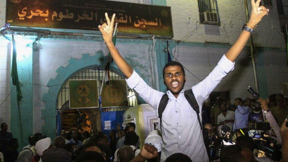 Family members shout slogans as they wait outside the Kobar prison in north Khartoum to welcome their loved ones after Sudan released dozens of opposition activists who were arrested last month when authorities cracked down on protests against rising food prices