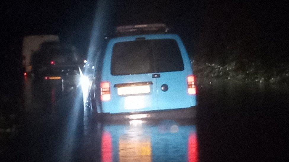 Blue van in water