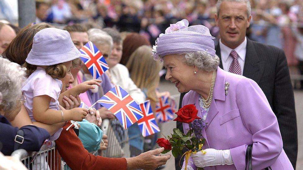 The Queen Talking To People In The Crowd Waving Union Jacks During A Walkabout In Kettering, Northamptonshire. June, 2001,