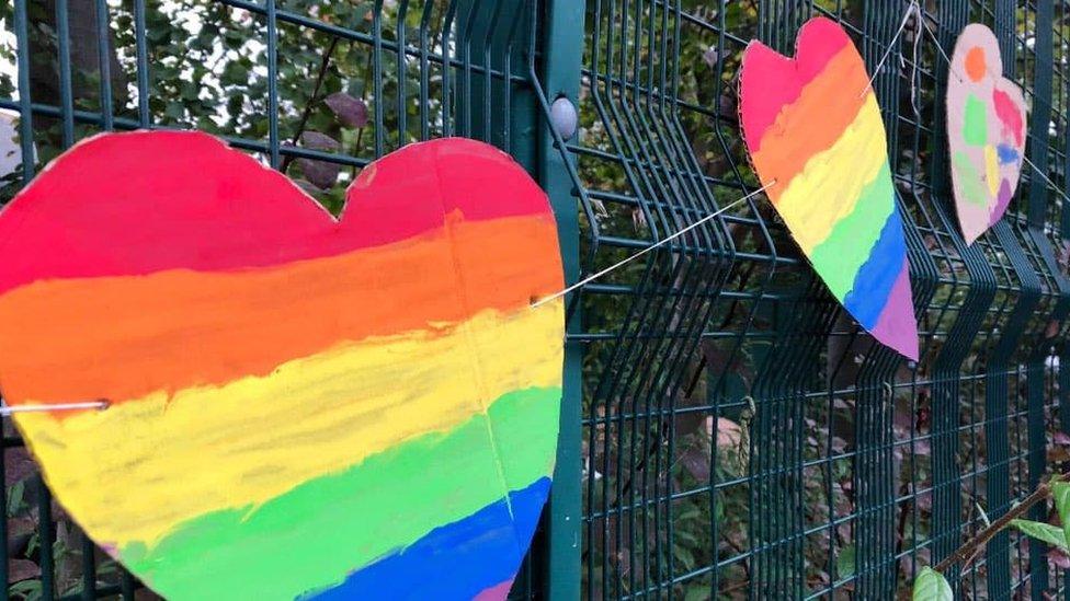 Rainbow hearts and flags covered the school gates.