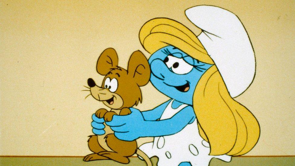 smurfette holding a mouse