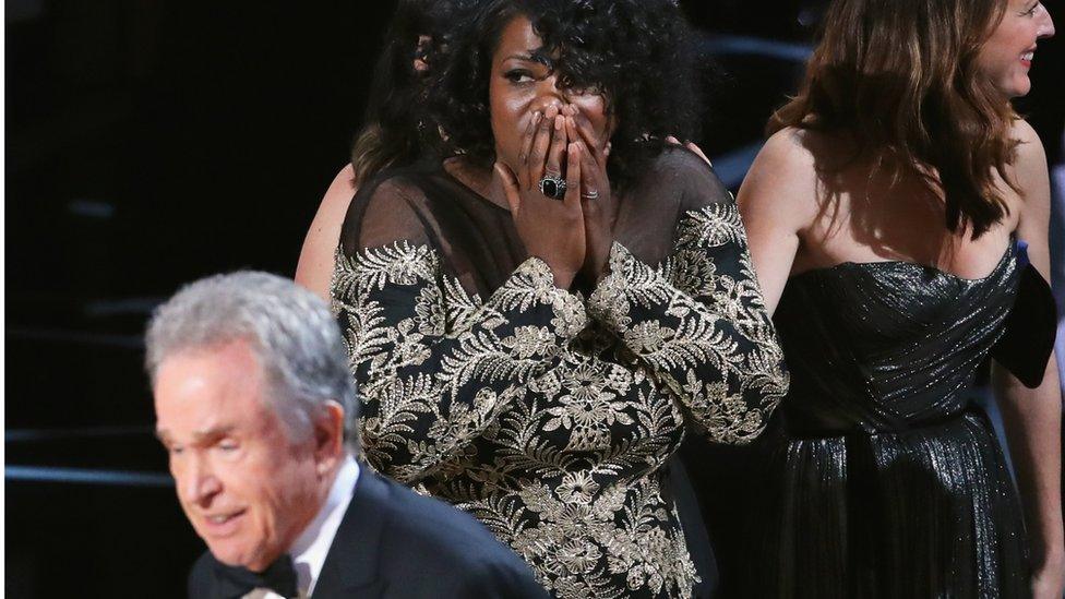 Moonlight editor Joi McMillon looks on, with award presenter Warren Beatty in the foreground