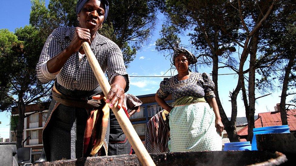 South African women prepare large quantities of traditional beer (umqombothi) for the African National Council's 100th anniversary on January 4, 2012, in Bloemfontein, South Africa.