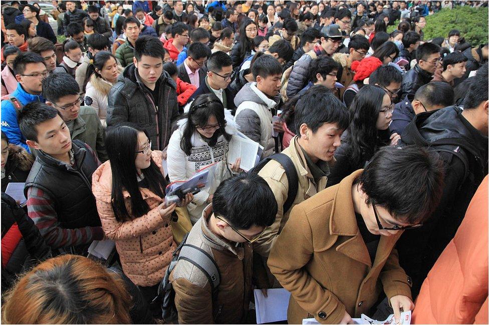 Candidates prepare outside the civil service examination room at Nanjing Forestry University on 29 November 2015 in Nanjing, Jiangsu Province of China. About 1.4 million people signed up for the civil service examination for 270,000 places this year.