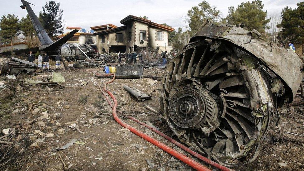 Emergency services personnel work at the scene of a plane crash in Alborz province, Iran (14 January 2019)