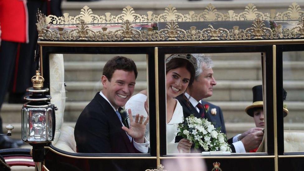 Princess Eugenie of York and her husband Jack Brooksbank walk down the West Steps of St Georg's Chapel