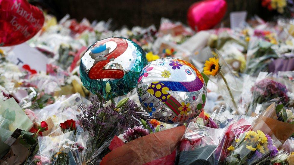 Ballons saying 22 alongside floral tributes in St Ann's Square