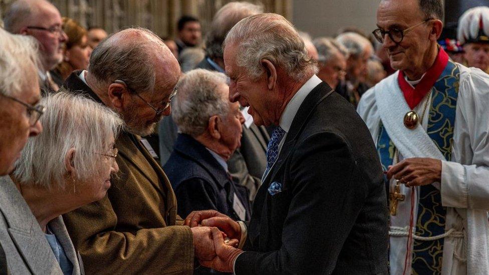 The King handing money out during a ceremony