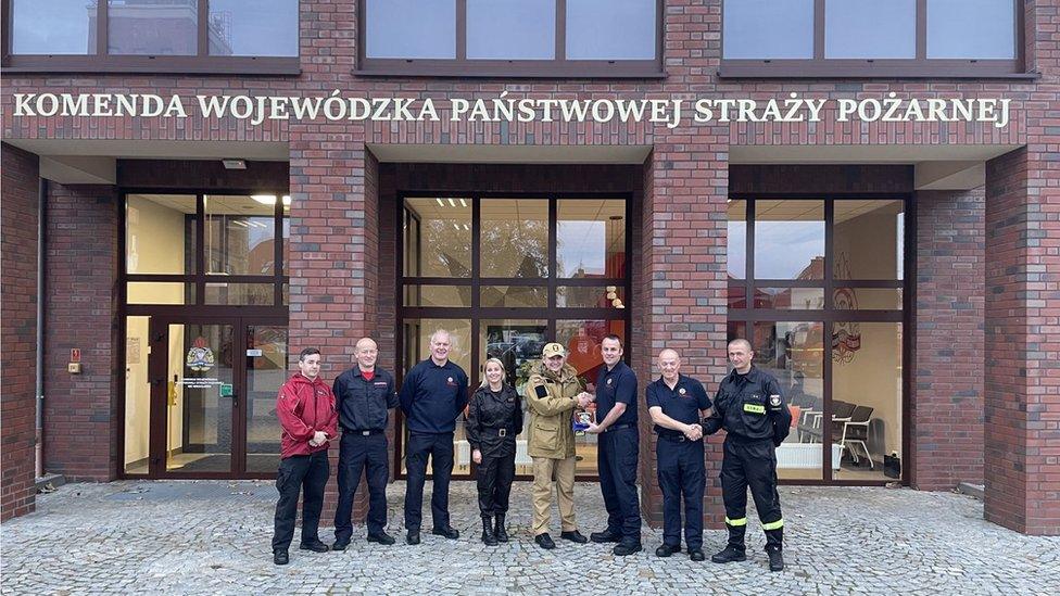 Firefighters outside of a building in Poland