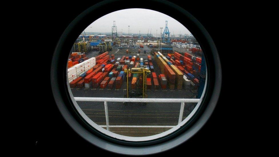 Ship freight containers sit on Tilbury Dock