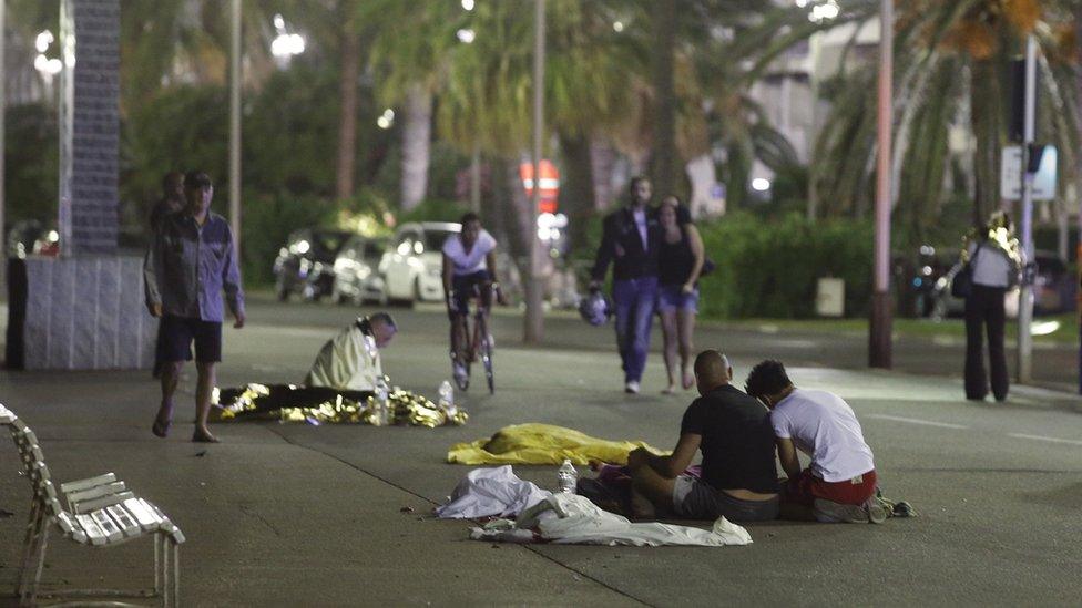 Aftermath of the attack, with covered bodies on ground