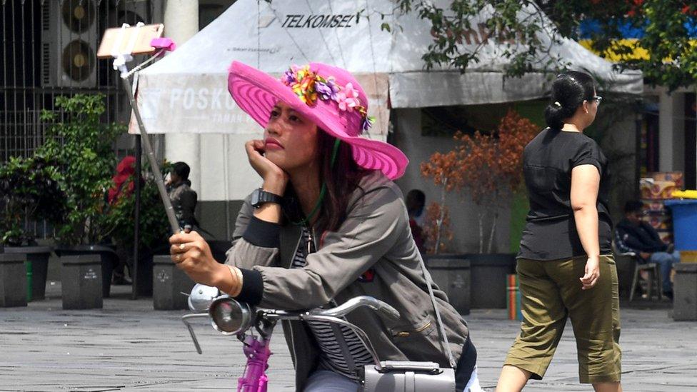 Woman taking a selfie in Jakarta's main square