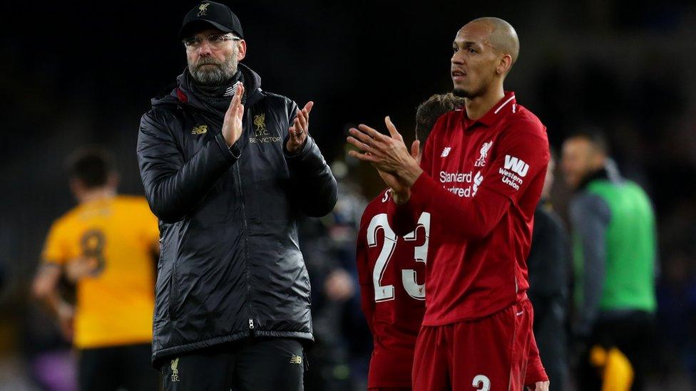 Jurgen Klopp manager of Liverpool and Fabinho of Liverpool applaud after their 2-1 defeat.