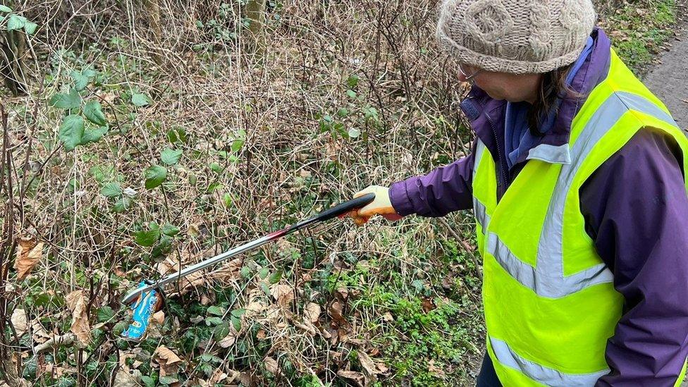 Laura Van Toller picking up litter