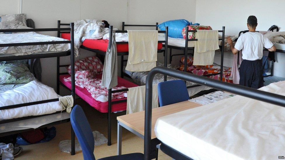 A Syrian man arranges his bed at the refugee reception centre in Ellwangen, Germany (3 August 2015)