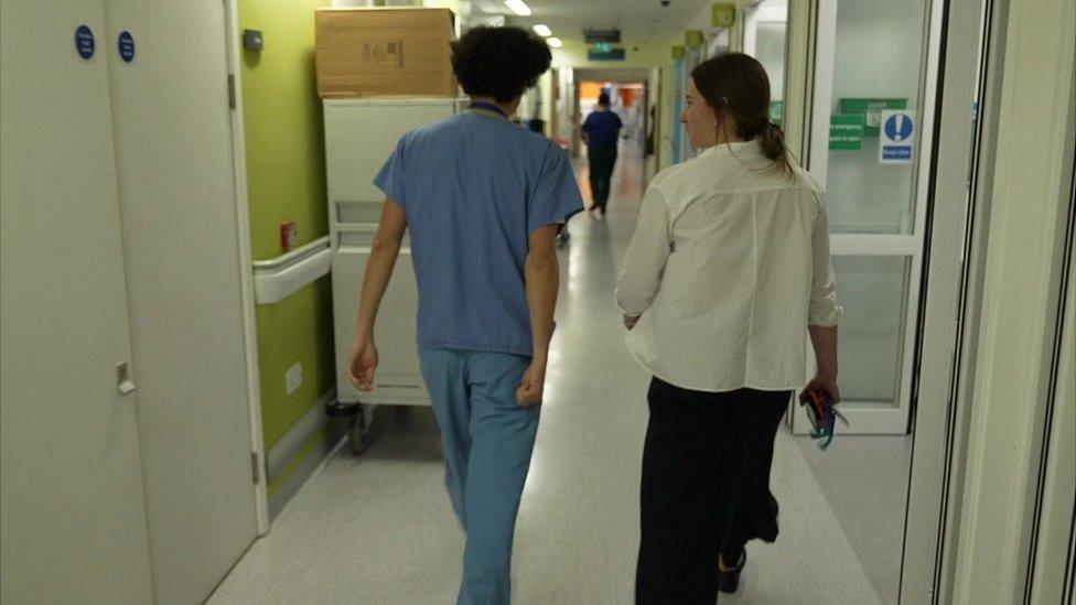 Hospital staff walking down corridor