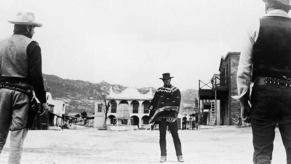 Clint Eastwood stares down his adversaries during a showdown in a still from the film, A Fistful of Dollars