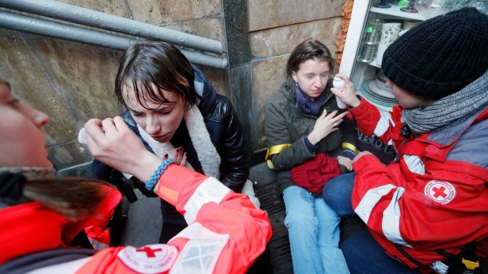 Paramedics rinsing the eyes of activists