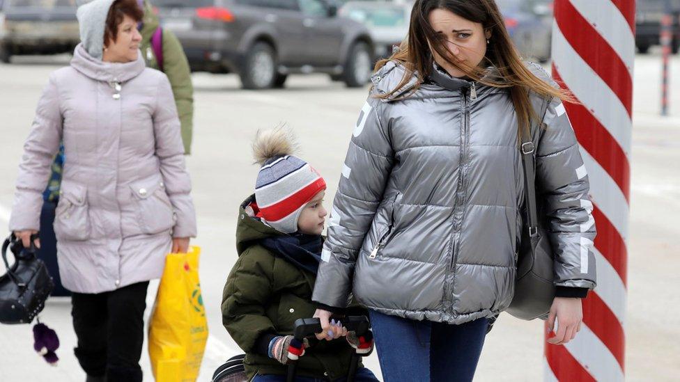 Ukrainians arrive at the border crossing between Ukraine and Moldova