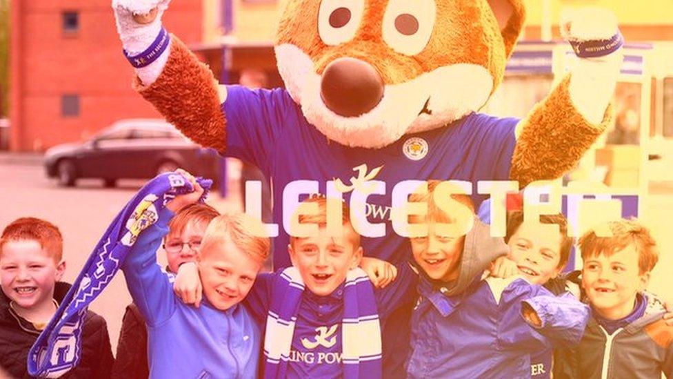 Leicester fans celebrate with the team's mascot.