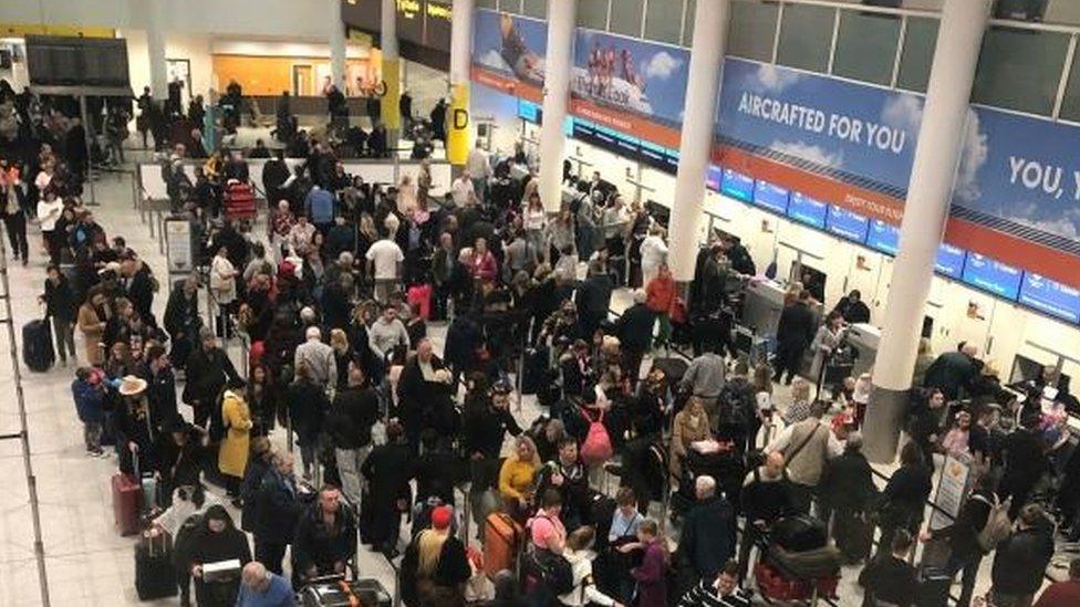 Passengers queue at Gatwick