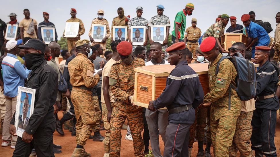 Burkina Faso's servicemen carry a coffin during the burial of the soldiers killed in Gaskinde, in Ouagadougou - 8 October 2022