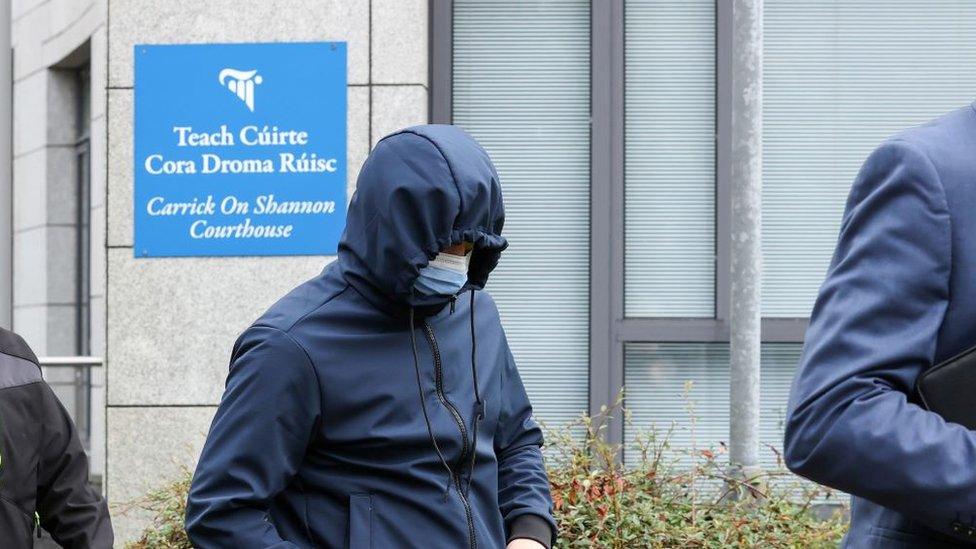 Serge Kelly leaving Carrick-on-Shannon District Court on Tuesday, his face covered with a blue mask and hood