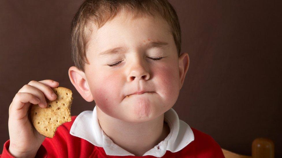 Child-eating-a-chocolate-biscuit