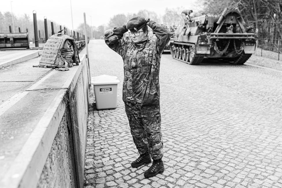 Craftsman Carla Knight, driver of an armoured recovery vehicle parked and ready for loading on to rail flats at the Belsen railway siding, Germany