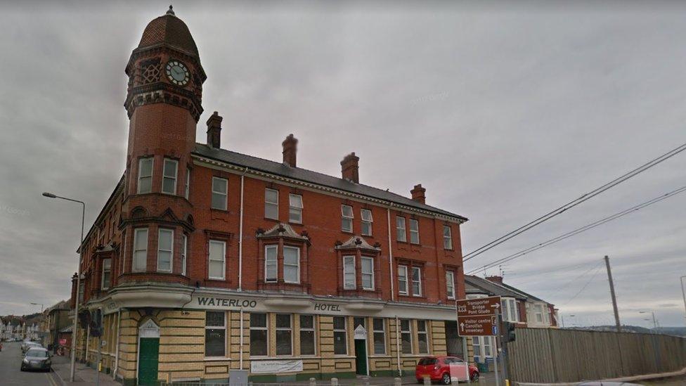 A photo of the Waterloo Hotel in Newport - which is a three storey red bricked building. The photo is taken an overcast day