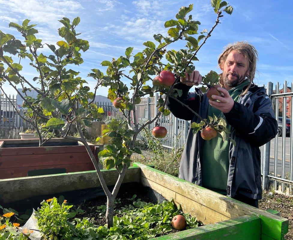 Martin inspects an apple