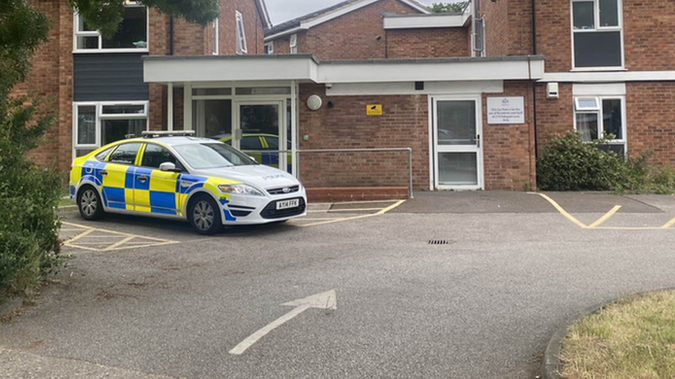 Police cars outside a temporary housing unit in Ipswich