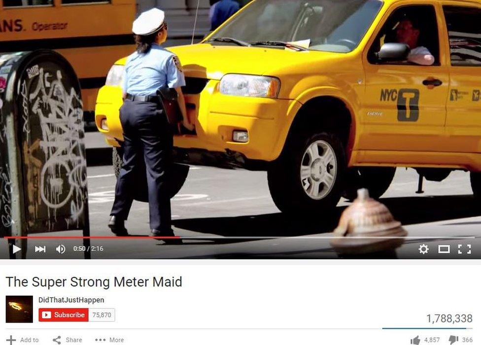 Actor pretending to be traffic warden lifting rigged yellow cab in New York