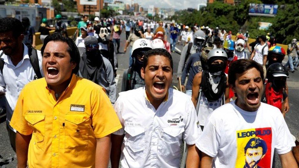 Deputies of the opposition Carlos Paparoni, (L) Jose Manuel Olivares (C) and Juan Andres Mejias shout slogans during a march to state Ombudsman's office in Caracas, Venezuela May 29, 2017.