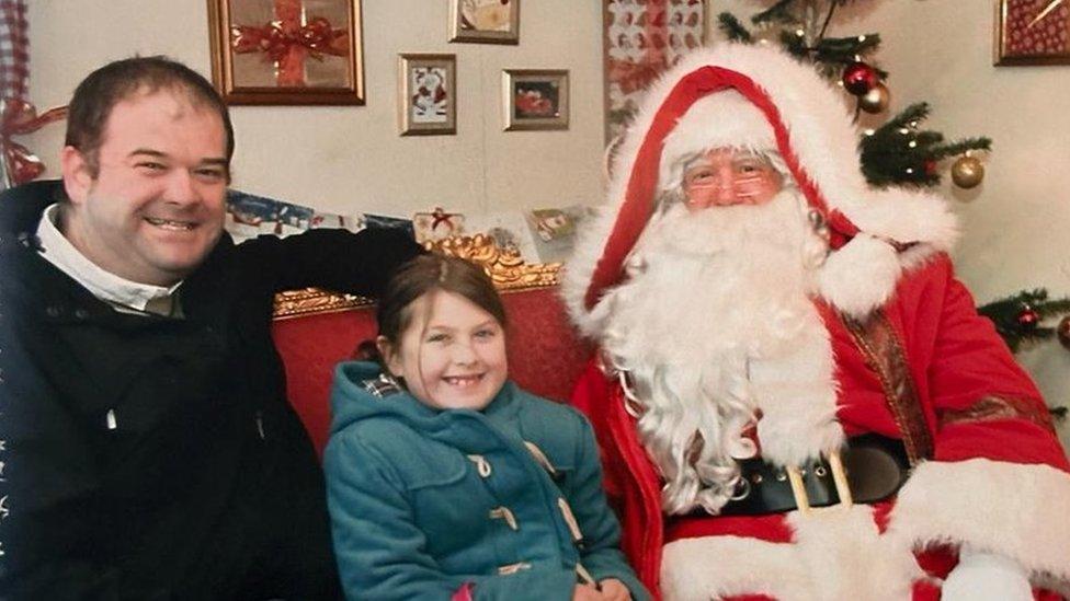 Ella and her father visiting Santa