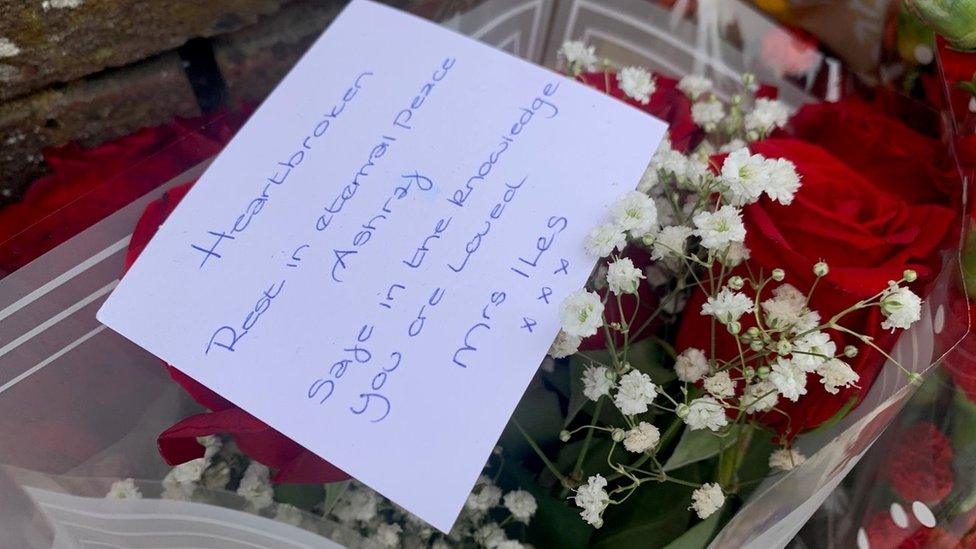 Flowers with a condolence card