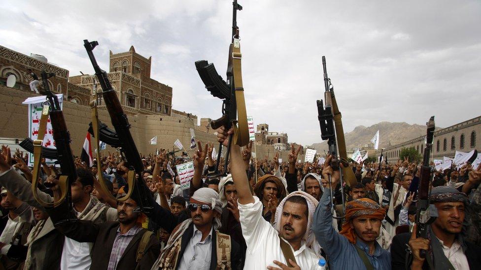 Houthi rebels hold up their weapons as they chant slogans during a rally against Saudi-led air strikes in Sanaa