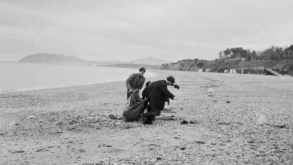 students with head in sack on Killiney beach