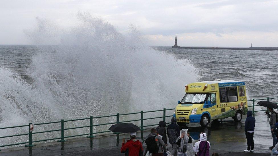 Wave next to ice cream van at seafront