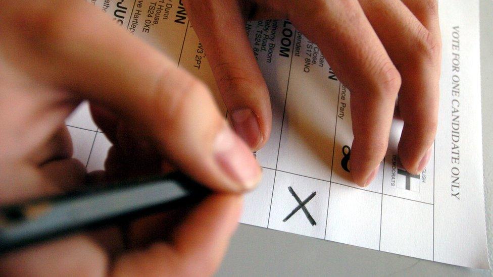 Woman filling out ballot