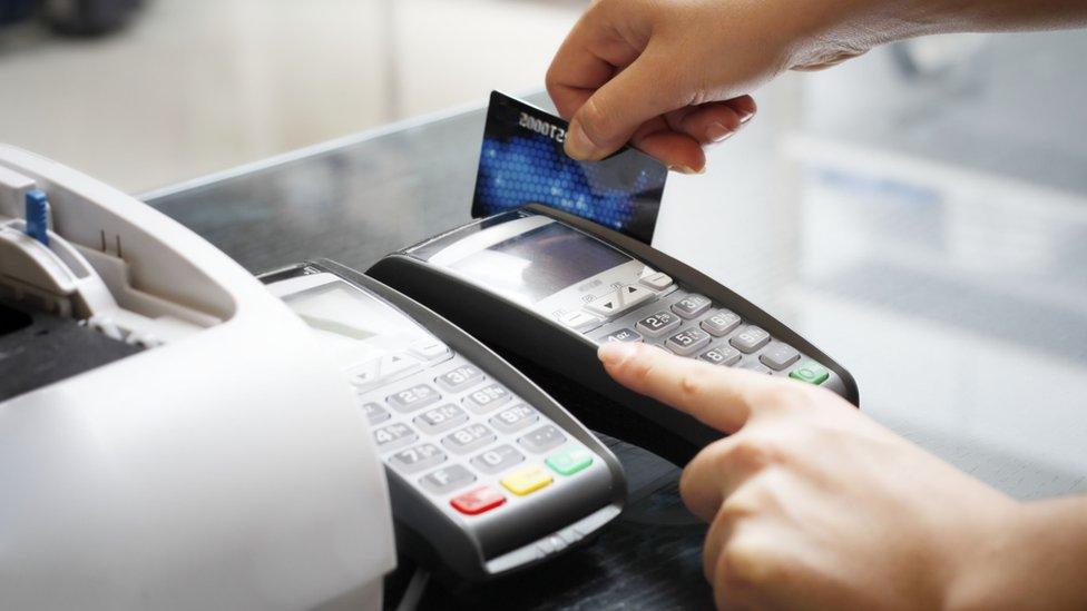 Credit card being swiped in a payment machine