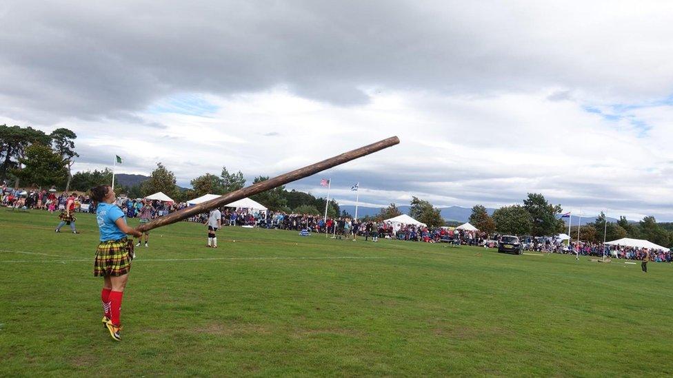 Celine Freeman-Gibb throwing a caber at a games in Scotland