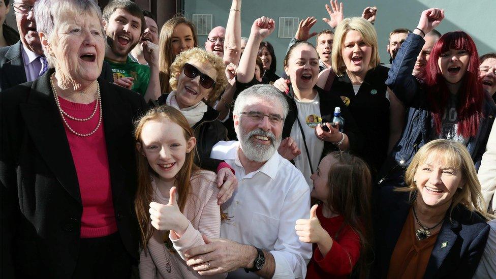 Sinn Féin president Gerry Adams celebrates with his supporters after his election