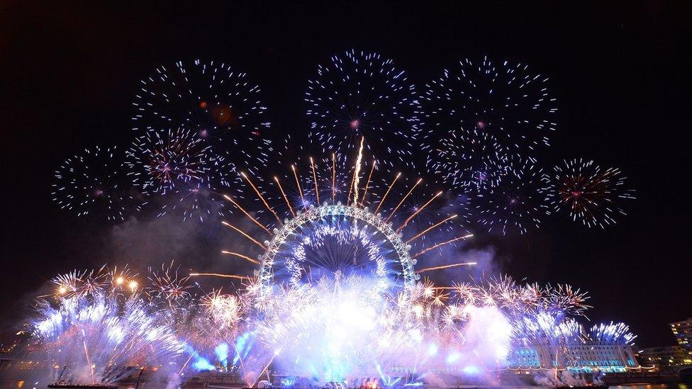 Fireworks light up the sky over the London Eye in central London during the New Year celebrations