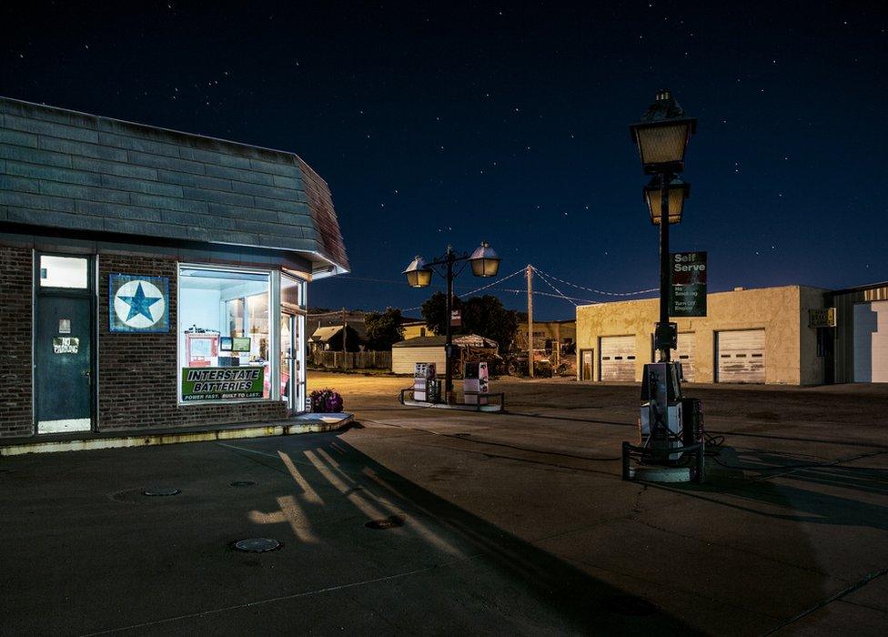 A night view of a shop, a night sky full of stars above