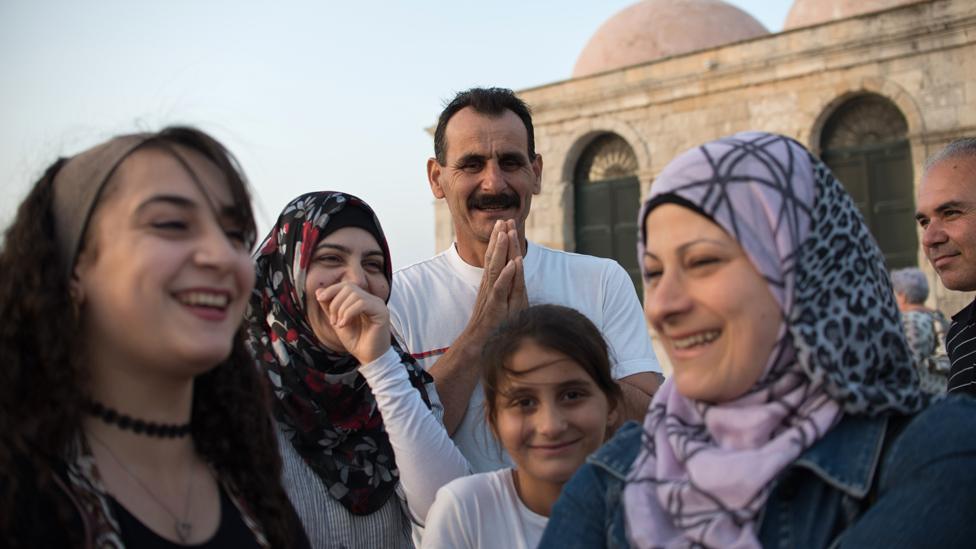 Ahmed surrounded by members of his family