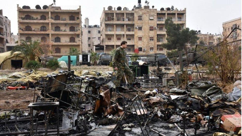 A Russian soldier inspects the damage at a field hospital reportedly destroyed by rebel shelling on 5 December, 2016 in the Furqan neighbourhood of the government-held side of western Aleppo.