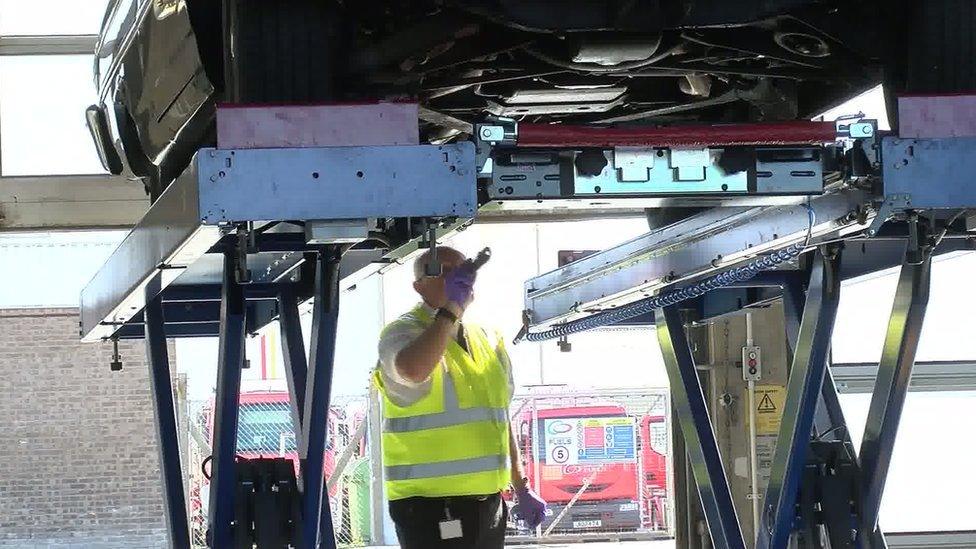 Mechanic checks under car