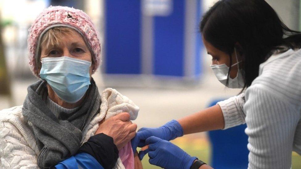 Woman receiving Covid vaccine in London